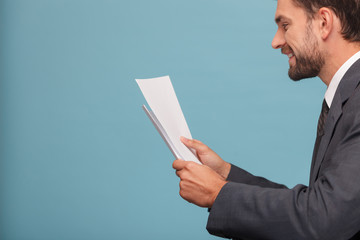 Attractive young man in suit with documents