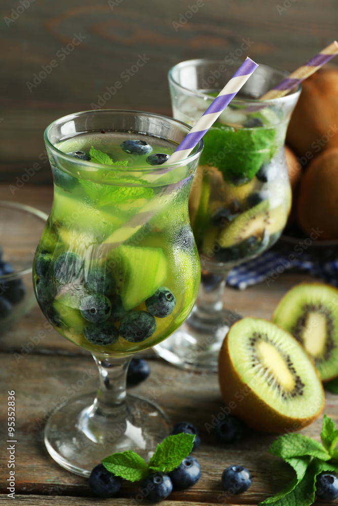 Sticker kiwi and blueberry cocktails on wooden background