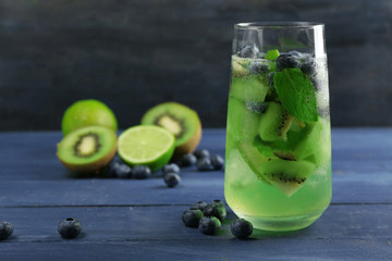 Kiwi and Blueberry cocktail on color wooden background