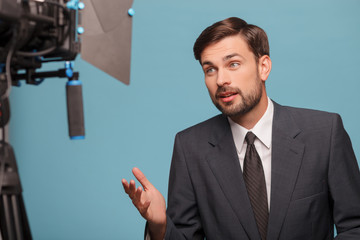 Cheerful young reporter is telling some news