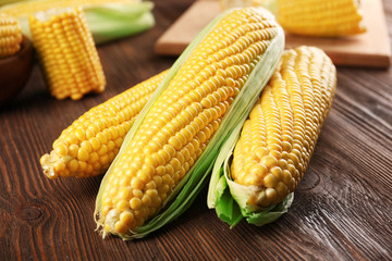 Ripe corn on wooden background