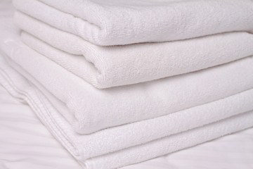 Stack of white and soft towels. Using Laundry Detergents  conditioners.