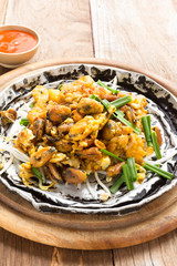 Crisp fried mussel pancake on old wood