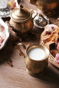 Antique tea-set with Turkish delight and baking on table close-up