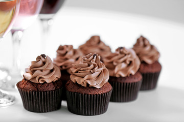 Tasting of wine and chocolate cupcakes, close up