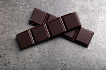 Dark chocolate pieces on  dark gray background