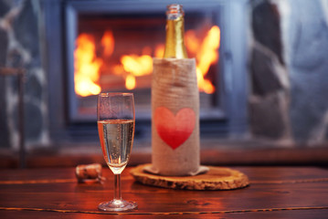 Bottle of wine on table, on fireplace background