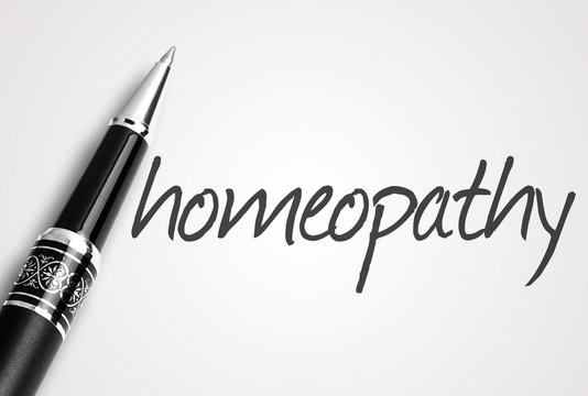 pen writes homeopathy on white blank paper