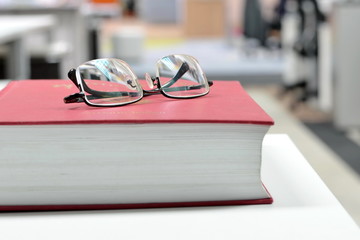 Eyeglasses on book/Eyeglasses on book at workplace.
