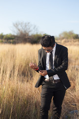 Asian male wearing a black suit