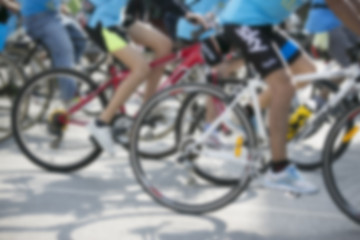 Fototapeta na wymiar bicycle wheel detail with blurry cyclist