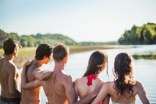 Back view of a group of teenagers looking at the horizon 
