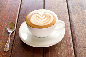 Hot coffee in a white cup on table