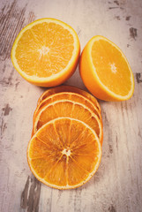 Vintage photo, Dried and fresh orange on old wooden background