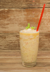 Apples smoothie on wooden floor.