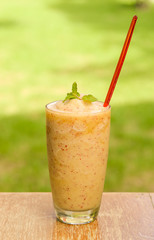 Apples smoothie on wooden floor.