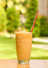 Apples smoothie on wooden floor.