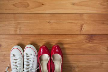 couple shoes over wooden deck floor.