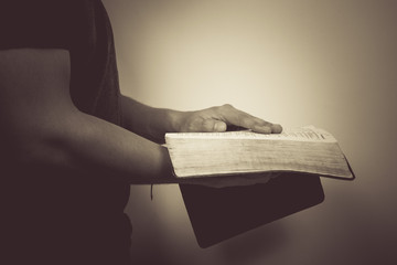 Vintage tone of man reading the Holy Bible.