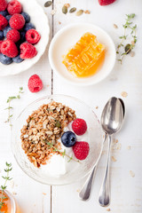 Healthy breakfast. Granola with pumpkin seeds, honey, yogurt, fresh berries .