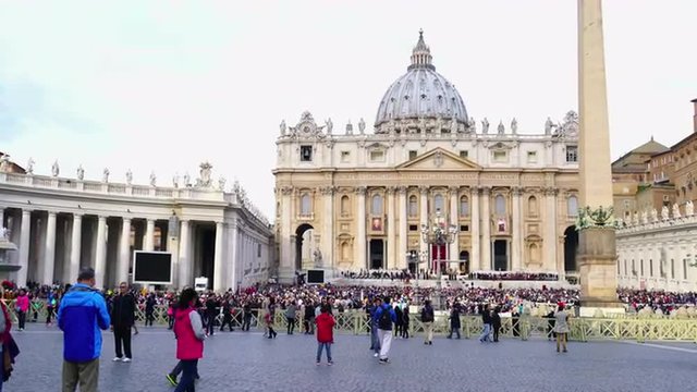 Saint Peter's Square, Vatican City - October 18, 2015 : People and tourists praying together at Saint Peter's Square in Vatican City on sunday October 18, 2015.
