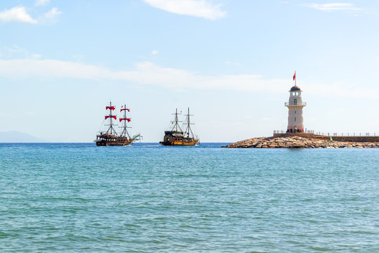 Lighthouse and sail ships in the Mediterranean sea