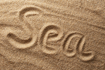 Fototapeta na wymiar Sea written on sand
