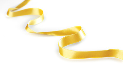 Golden curly ribbon isolated on white