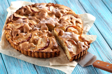 Homemade apple cake on blue wooden table