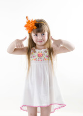 the young girl on the white dress  posing and pointing hand for the camera showing funny faces isolated on the white background