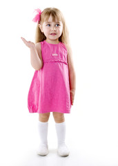 little girl in a pink dress posing for the camera showing funny faces
