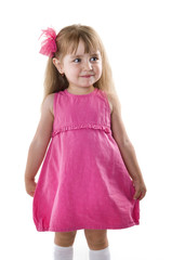 little girl in a pink dress posing for the camera showing funny faces