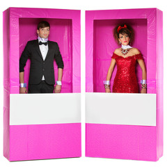 Boy and girl looking like dolls in boxes