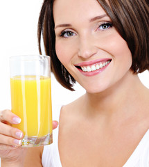 Young smiling woman with glass of orange juice