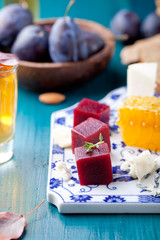 Crostini, bruschetta with plum, berry marmalade and goat cheese 