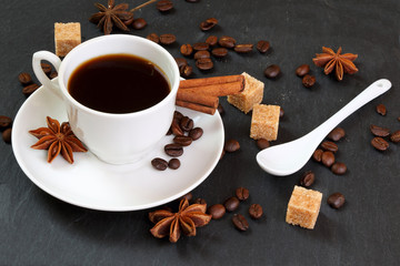Obraz na płótnie Canvas Black coffee with cinnamon, anise and cane sugar