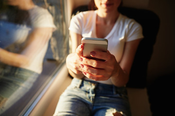 young casual woman using smart phone  at home.