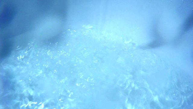 flow of blue water pours into the bath typed HD