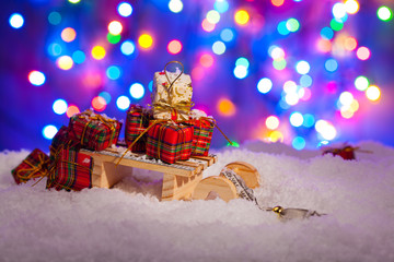 Sack Santa Claus with presents on snow, on a background of color