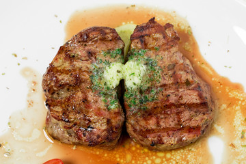 Grilled steak with green butter.