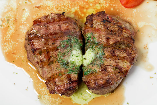 Grilled steak with green butter.