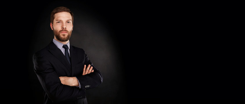 Closeup Portrait Of Handsome Businessman, Isolated On Black Background With Copy Space.