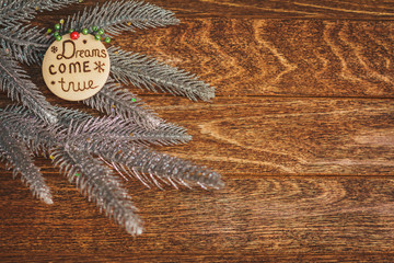 Christmas tree with burned inscription Dreams come true on wood