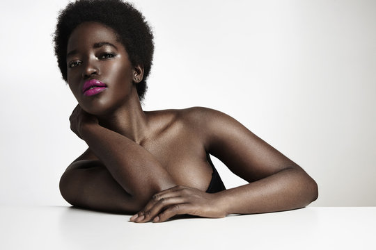 black woman with bright lipstick and strobbing skin