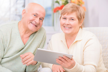 Adult couple holding laptop 