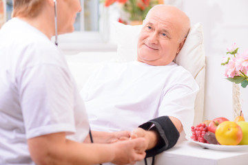 Fototapeta premium Nice adult couple measuring pressure 