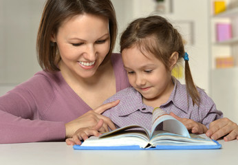 Fototapeta na wymiar Mother doing homework with daughter