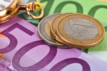 coins, banknotes and pocket watch