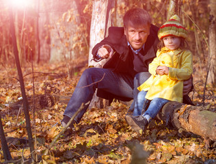 Father and Daughter Sitting in Forest and Watching Live Nature