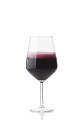 red wine poured into the glass on white